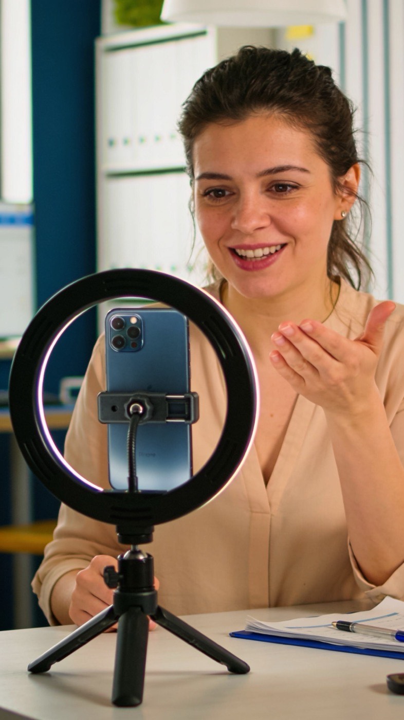 A business owner recording a short marketing video of herself