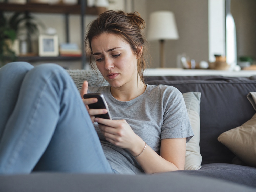 A visitor on the couch, thumb already swiping away