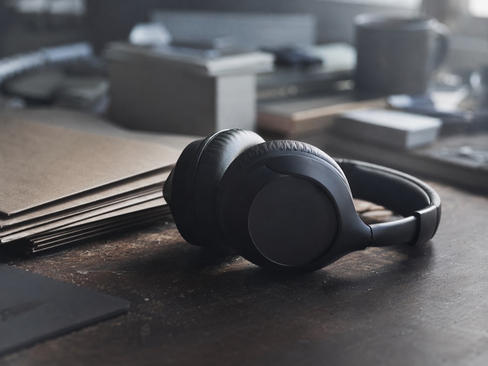 Headphones resting untouched on a cluttered desk
