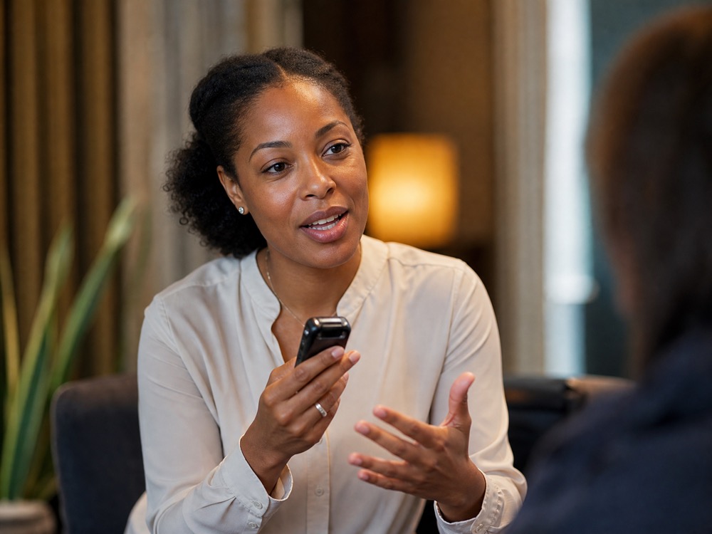 A small handheld recorder capturing a relaxed, natural conversation